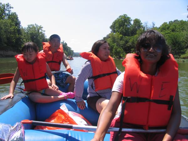Lab members row raft down the river
