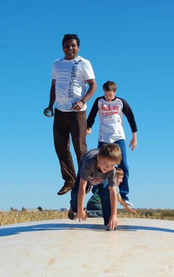 Sunil More and lab members jump on a trampoline